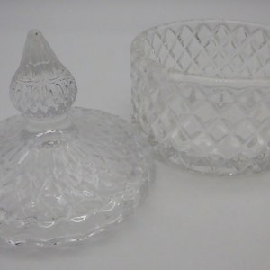 May include: A clear glass jar with a lid. The jar has a diamond pattern and the lid has a knob on top.