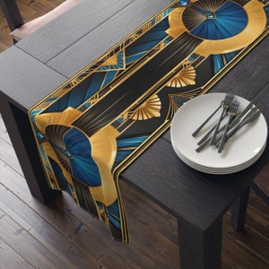 May include: A black and gold table runner with a geometric pattern featuring blue and gold accents. The runner has a modern art deco design.