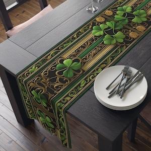 May include: A green and gold table runner with a shamrock pattern. The runner is on a dark wood table with a set of white plates and silverware.