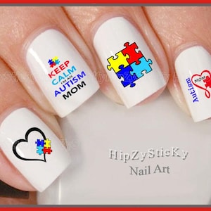 May include: Set of five nail art stickers featuring autism awareness designs. The designs include a puzzle piece, a heart with a puzzle piece, and the text "Keep Calm I'm an Autism Mom".