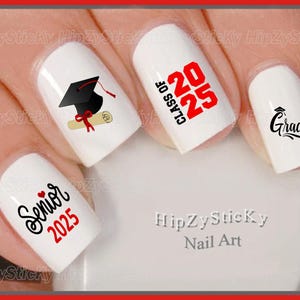 May include: White nail art featuring graduation-themed designs. Includes a mortarboard, diploma, and the words "Senior 2025", "Class of 2025", and "Grad" in black and red. The brand name "HipZySticky Nail Art" is also visible.