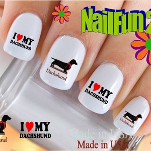 May include: Nail art decals featuring a black dachshund with a red bow tie and the text "I love my dachshund".