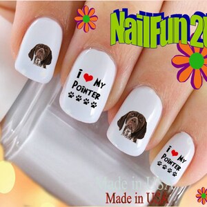 May include: White nail art with a German Shorthaired Pointer dog design and the text "I ❤️ My Pointer." The nails also have paw print accents. The text "NailFun2U" is visible in the background.
