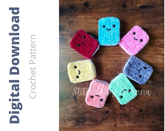 May include: A set of eight crocheted book-shaped plushies in various colors, including pink, blue, yellow, green, red, and gray. Each plushie has a simple embroidered face with eyes and a mouth.