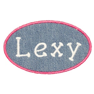 May include: A blue denim oval patch with a pink border and the name "Lexy" embroidered in white.