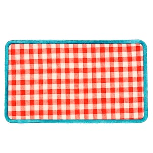 May include: A red and white checkered fabric patch with a turquoise blue border.