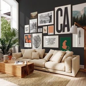 May include: A living room interior with a beige sectional sofa, a wooden coffee table, and a wall gallery featuring various framed prints. The prints include a black and white image of a forest, a black and white image of a tree trunk, a print with the text "good vibes only", a print with the text "209", a print with the text "CA", and a print with the text "Of all the PATHS you take in life, make sure a few of them are DIRT."