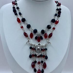Ad Infinitum - black and red statement necklace with skeleton pendant