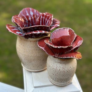 May include: A set of three ceramic mugs with a speckled, matte finish. The mugs are in shades of cream, light gray, and dark gray. Each mug has a simple, minimalist design, perfect for coffee or tea.