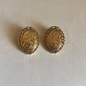 Vintage 1928 gold tone floral etched oval clip on earrings