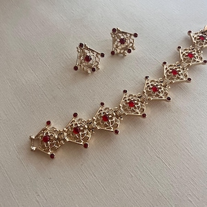 Vintage Sarah Coventry 1970 ‘Serenade’ gold tone red rhinestones bracelet and clip on earrings jewelry set