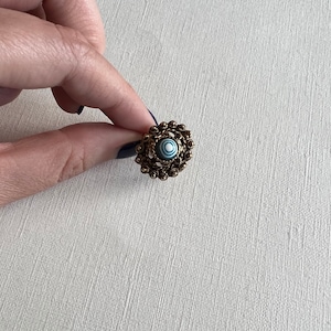 Vintage Vogue gold tone filigree stamped with blue and white swirl bead adjustable ring