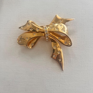 Vintage Joan Rivers gold tone rhinestone ribbon bow brooch