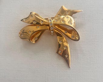 Vintage Joan Rivers goudkleurige strikbroche met strassteentjes