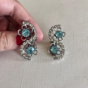Vintage Mid-century silver tone light blue rhinestone double flower clip on earrings