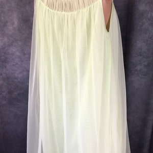 May include: A pale yellow sheer nightgown with a gathered neckline and a sleeveless design.