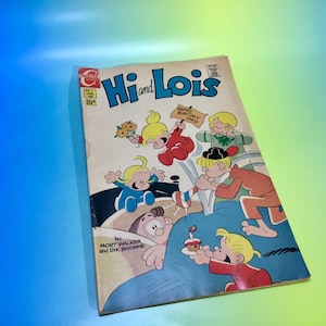 May include: A vintage comic book cover featuring the characters Hi and Lois. The cover is yellowed with age and features a colorful illustration of the characters celebrating a birthday. The title "Hi and Lois" is printed in red and blue letters. The comic book is published by the company "Hallmark Comics".