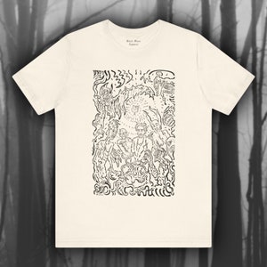 May include: A white t-shirt with a black and white graphic print of a stylized illustration of a group of people standing around a central figure. The text "Black Moon Apparel" is printed on the shirt.