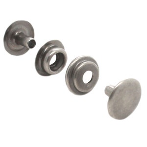 May include: A set of four silver metal snap fasteners. The fasteners are in different stages of assembly, showing the cap, socket, stud, and post.