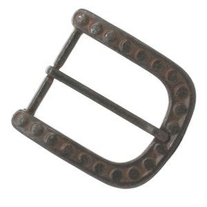 May include: A silver-toned metal belt buckle with a decorative design of small circles around the edge.