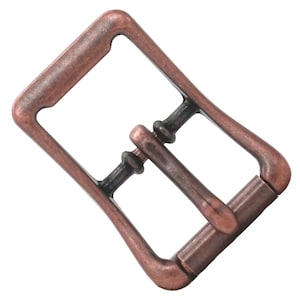May include: A copper-toned metal buckle with a rectangular frame and a sliding pin. The buckle is designed for a belt or strap.