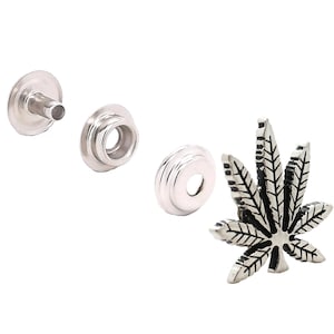 May include: Silver-toned metal snap fasteners with a silver-toned metal marijuana leaf charm. The snap fasteners are used for attaching fabric together.