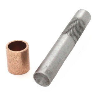 May include: A silver leather punch tool with a textured handle and a copper grommet.