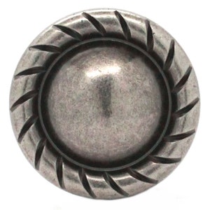May include: A silver-toned metal knob with a raised, rounded center and a decorative, rope-like border.