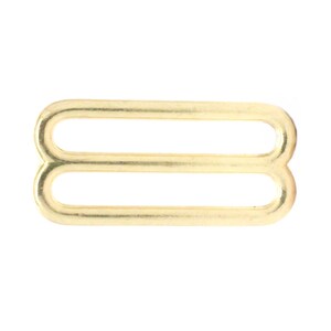 May include: Gold metal slider buckle with two loops.