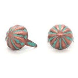 May include: Two copper-colored metal tacks with a turquoise blue design. The tacks have a rounded head with a raised, starburst pattern.