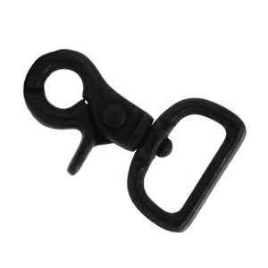 May include: Black metal swivel hook with a D-ring. The hook is designed for attaching to a belt loop or other item.
