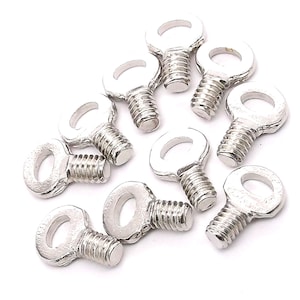 May include: Ten silver-toned eyelet screws with a threaded shaft and a small loop at the top. The screws are scattered on a white surface.