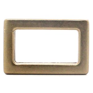 May include: A rectangular metal buckle loop with a smooth, matte brass finish. The hardware features rounded corners and a hollow center, designed with a flat, uniform surface profile and a consistent metallic tone throughout the entire frame.