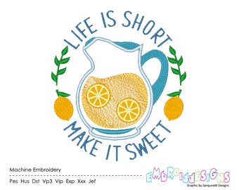 May include: A machine embroidery design featuring a blue-outlined pitcher filled with yellow lemonade and two lemon slices. The text reads LIFE IS SHORT MAKE IT SWEET, framed by green leafy branches and two yellow lemons on either side of the pitcher.