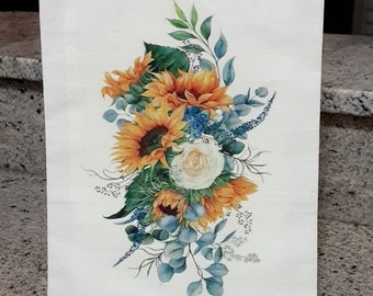 May include: A white tea towel featuring a watercolour design of sunflowers, a white rose, and eucalyptus leaves. The text "IdleTymeCreations.etsy.com" is printed at the bottom.