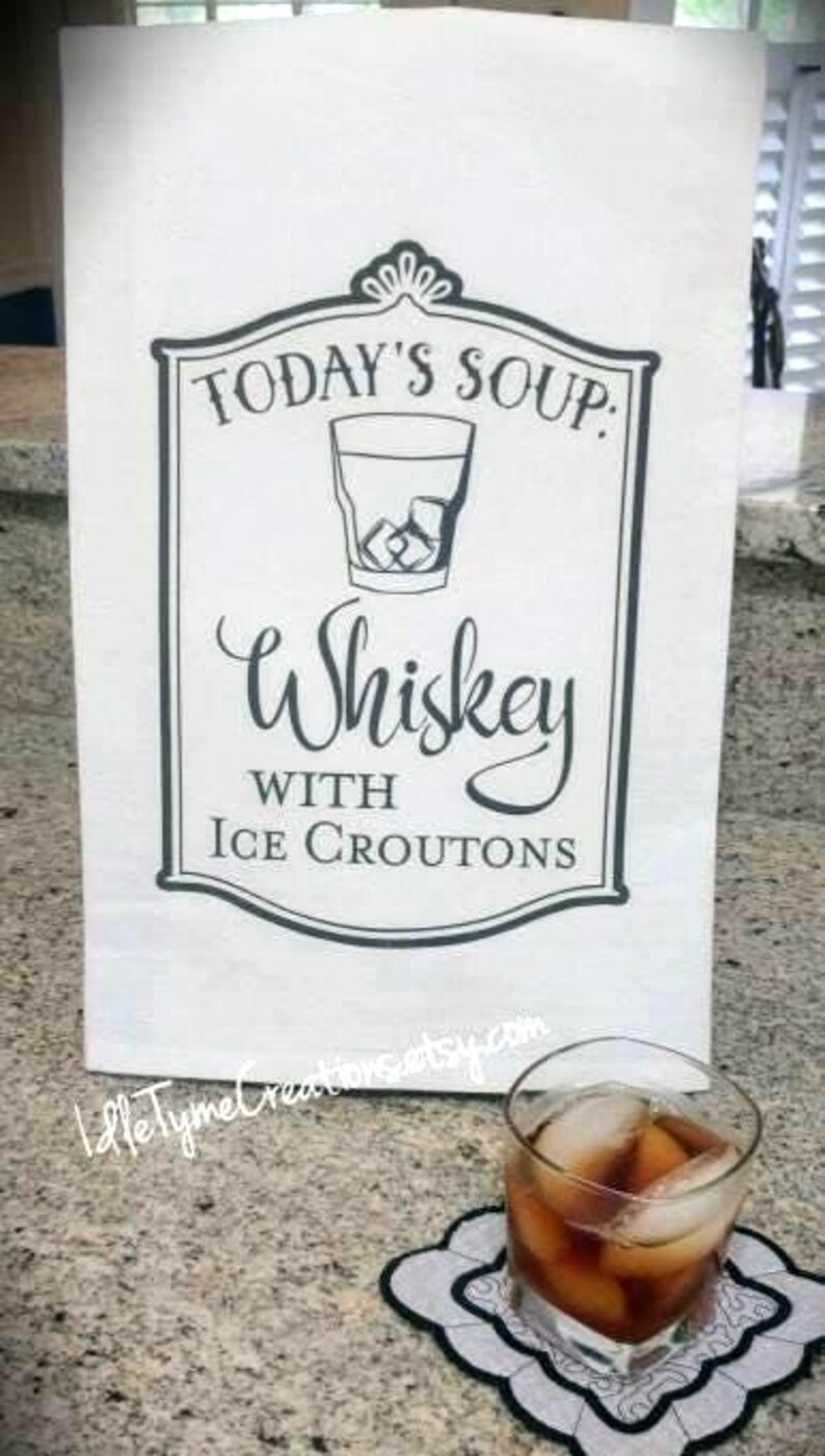 May include: A white kitchen towel with a black and white graphic that says "Today's Soup: Whiskey with Ice Croutons".