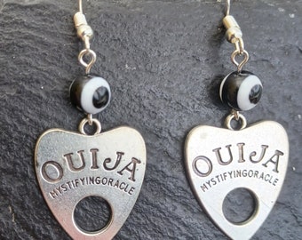 Ouija planchette and eye earrings