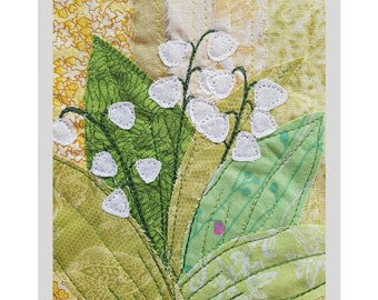 May include: A collage art quilt featuring a lily of the valley design. The quilt is made of various fabrics in shades of green, white, and yellow. The quilt is 11 x 12.5 inches and can be framed to fit an 8 x 10 inch mat.
