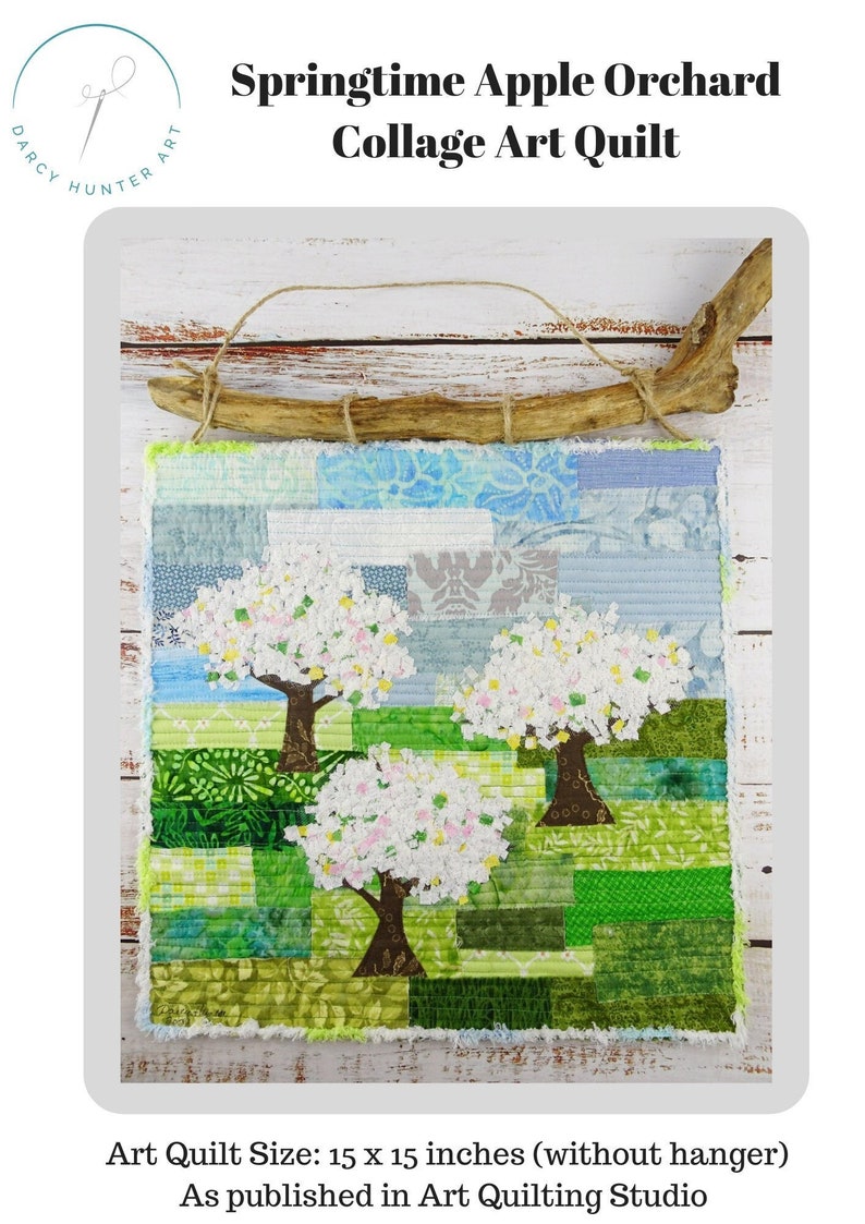 May include: A handmade patchwork quilt depicting a spring scene with three apple trees in bloom. The quilt is made of various fabrics in shades of green, blue, and white. The quilt is 15 inches by 15 inches and is hung on a wooden branch.