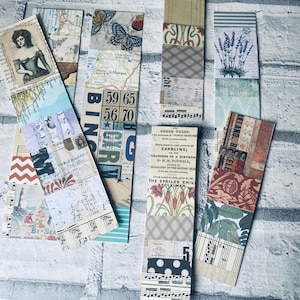 May include: A selection of handcrafted paper bookmarks with a vintage design. Each bookmark is a unique collage of patterned papers, including maps, sheet music, and botanical illustrations. Some bookmarks display text, including the words "BING" and "BY SEA".