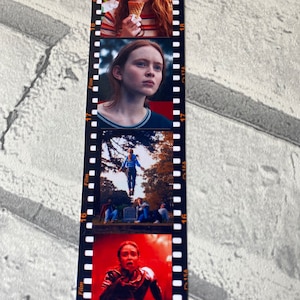May include: A vertical bookmark with four images of a young woman with red hair. The images are in a film strip format with the numbers 15, 16, 17, and 18 visible. The first image shows the woman smiling and holding an ice cream cone. The second image shows the woman looking to the side with a serious expression. The third image shows the woman floating in the air in a blue shirt and jeans. The fourth image shows the woman running with a scared expression on her face.