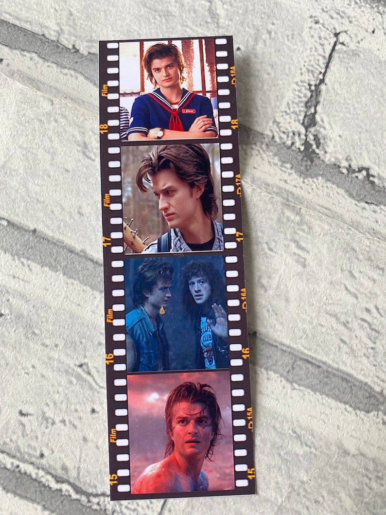 May include: A film strip bookmark with four images of a young man with brown hair. The images are in black and white and color. The bookmark is made of paper and has a black background with white film strip markings.