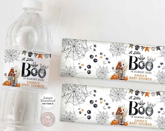 May include: Printable water bottle labels with a Halloween theme. The labels feature a black and white illustration of a house with a spider web, pumpkins, and the text "A Little Boo is Almost Due! Emma's Baby Shower".