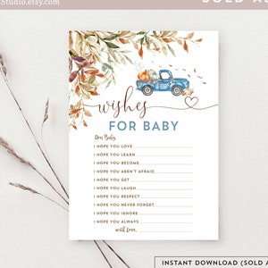 Könnte beinhalten: Eine druckbare Babyparty-Spielkarte mit dem Text "wishes FOR BABY". Die Karte zeigt eine Aquarellillustration eines blauen Lastwagens mit Kürbissen, umgeben von Herbstblättern. Der Text "SOLD AS-IS" ist ebenfalls sichtbar.
