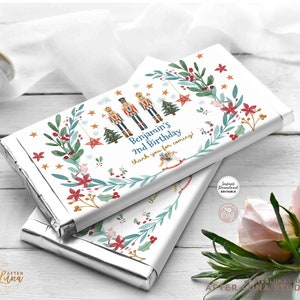 May include: A printable chocolate bar wrapper featuring a watercolor illustration of nutcracker soldiers, a Christmas tree, and a wreath. The text on the wrapper reads "Benjamin's 2nd Birthday, thank you for coming!"