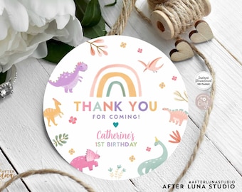 May include: A round, white printable tag with a dinosaur theme. The tag features a rainbow, dinosaurs, and the text "Thank You For Coming!" with a personalized name and birthday. The words "Instant Download Editable Template" are at the top.