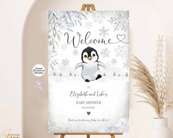May include: Welcome sign for a baby shower with a penguin illustration and snowflakes. The sign says "Welcome" and "To Elizabeth and Luke's Baby Shower 10.15.2020".