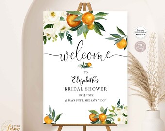 May include: A printable welcome sign for a bridal shower with a watercolor design of white flowers and orange citrus fruit. The sign says "Welcome to Elizabeth's Bridal Shower 10.15.20XX 46 Days Until She Says 'I Do!'".