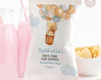 May include: A white chip bag with a blue and beige watercolor design featuring a teddy bear in a hot air balloon with the text "Elizabeth and Luke's Drive-Thru Baby Shower Roasted Potato Chips -Original-"