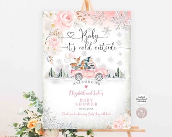 Może przedstawiać: Znak baby shower z motywem zimowym. Znak przedstawia różową ciężarówkę przewożącą leśne stworzenia, płatki śniegu i napis "Baby it's cold outside". Znak zawiera również imiona "Elizabeth and Luke's" i datę.